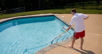 How to Clean a Pool: A Time Saving Guide man brushing the pool