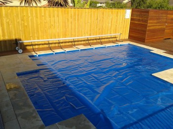 Swimming pool blanket covering pool