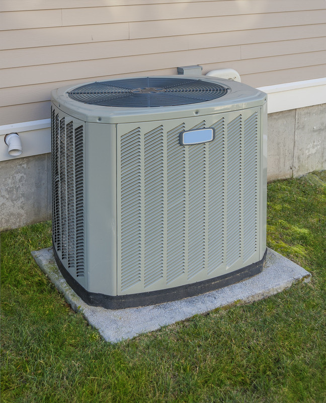 Swimming pool heat pump on a concrete pad.