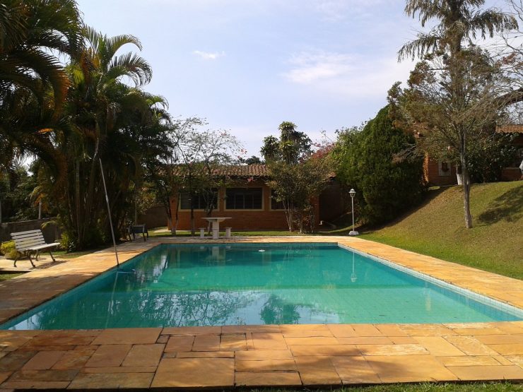 backyard swimming pool with cloudy water