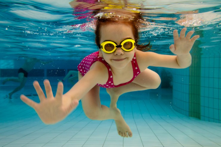 Girl swimming under water in a pool