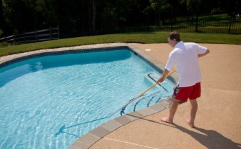 man brushing the pool