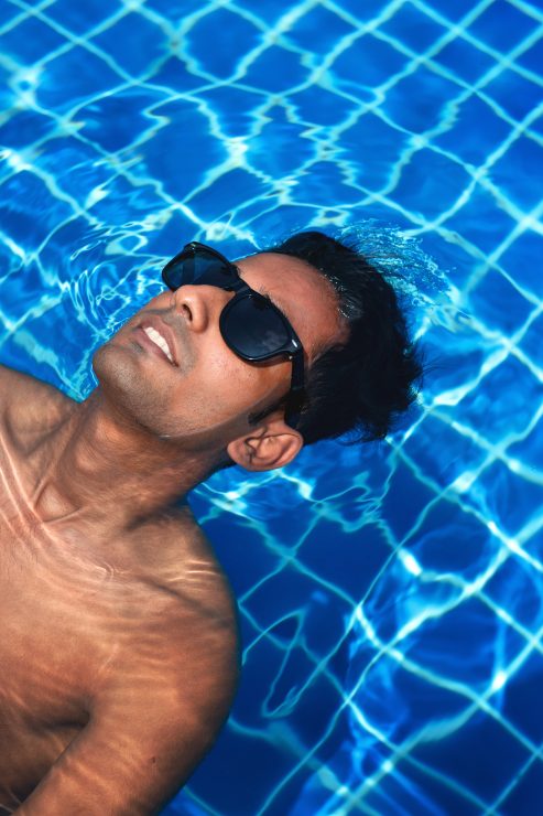 Man floating in the pool