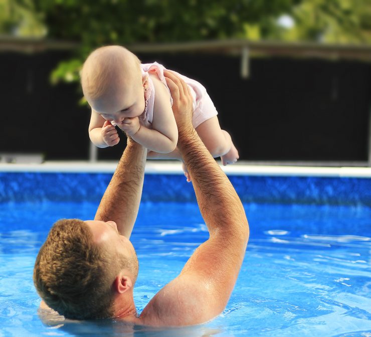 Man and Baby in the pool - Clarifier: how to fix cloudy swimming pool water