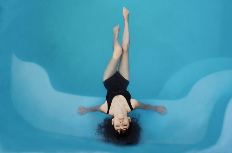 woman in a swimming pool with cloudy pool water