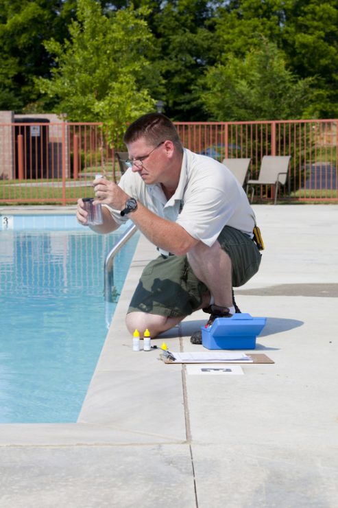 A man doing pool water testing.