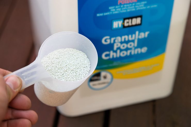 scoop of granulated chlorine 
stabilizer for swimming pools