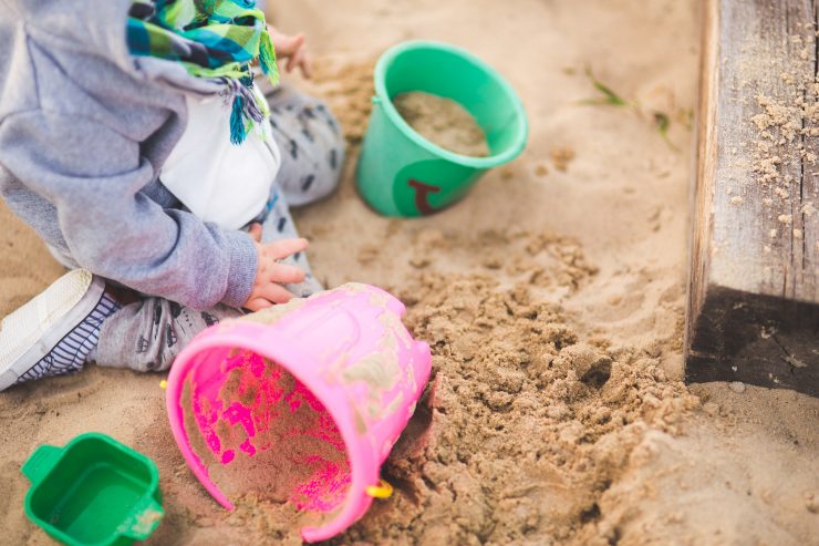 picture of a child playing in the sand pit