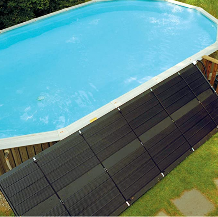 Solar pool heating system mounted on ground next to above ground pool.
