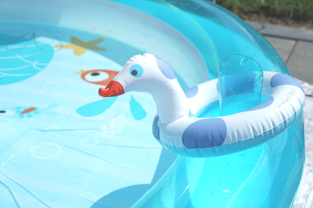 Aqua blue kiddie pool with duck floater 
