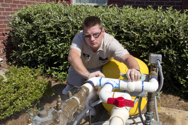 man fixing leaking pipes