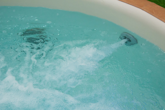 Swimming pool with return jets bubbling and aerating the water.