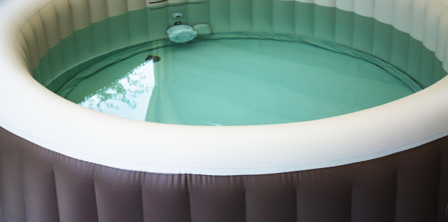 brown and white inflatable hot tub half filled with water