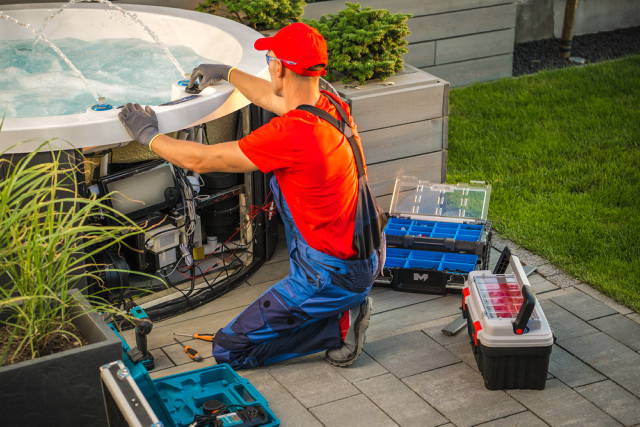 Electrician fixing electrical wirings of the hot tub.