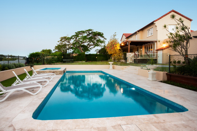 Swimming pool with stone coping and decking