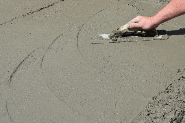 Man hand finishing concrete floor.