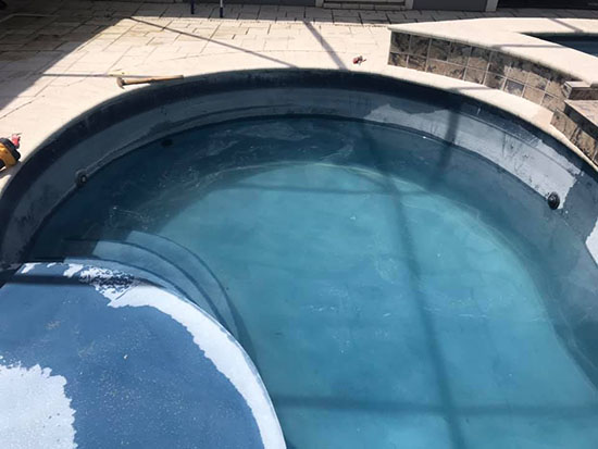 Heavy calcium deposits on pool sides.
