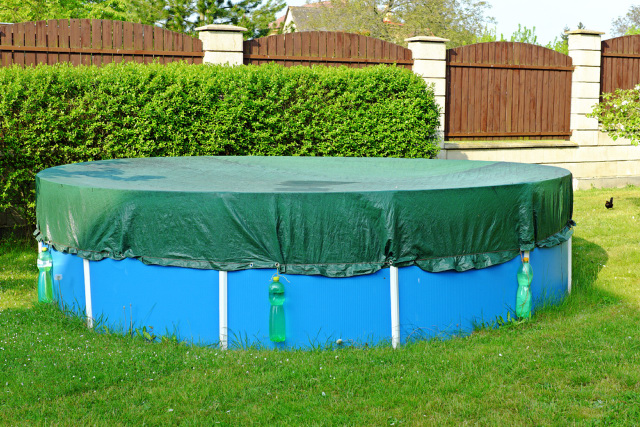 An above-ground pool with cover.