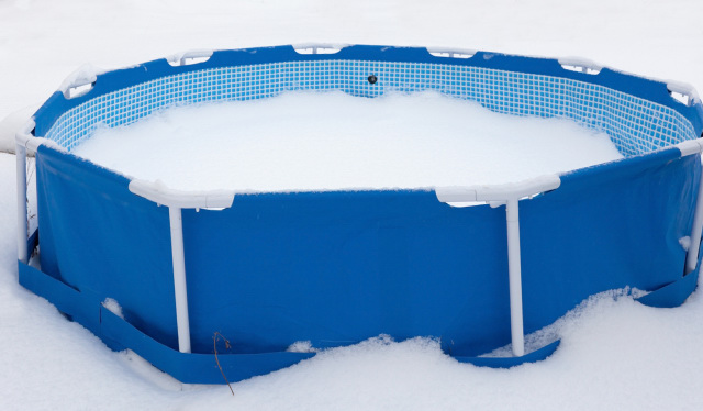 An uncovered above-ground pool during winter