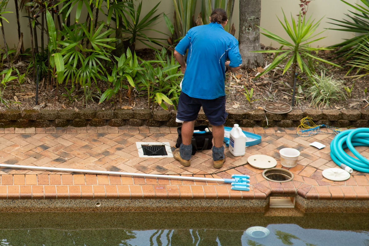 Pool technician preparing to test pool water.