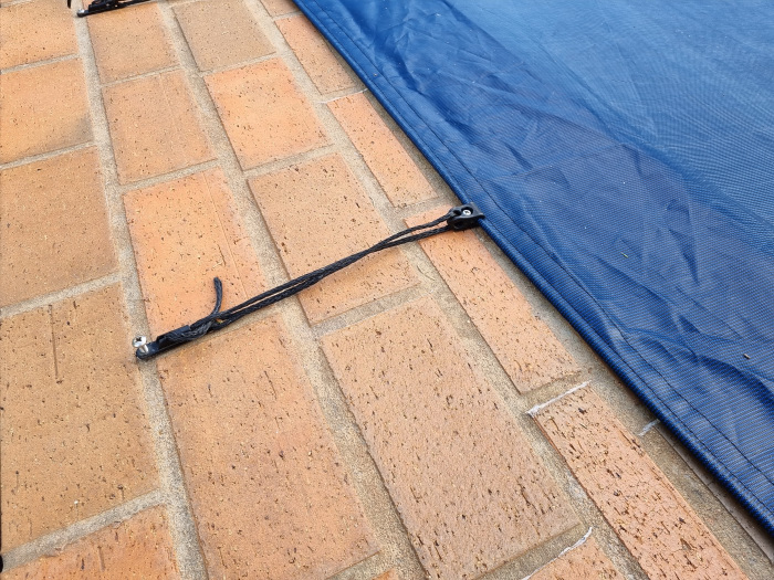 pool cover strapped in an anchor