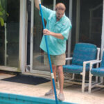 Jason Phillips author cleaning pool